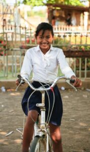 Srey Veth with her bicycle donated by ChildFund